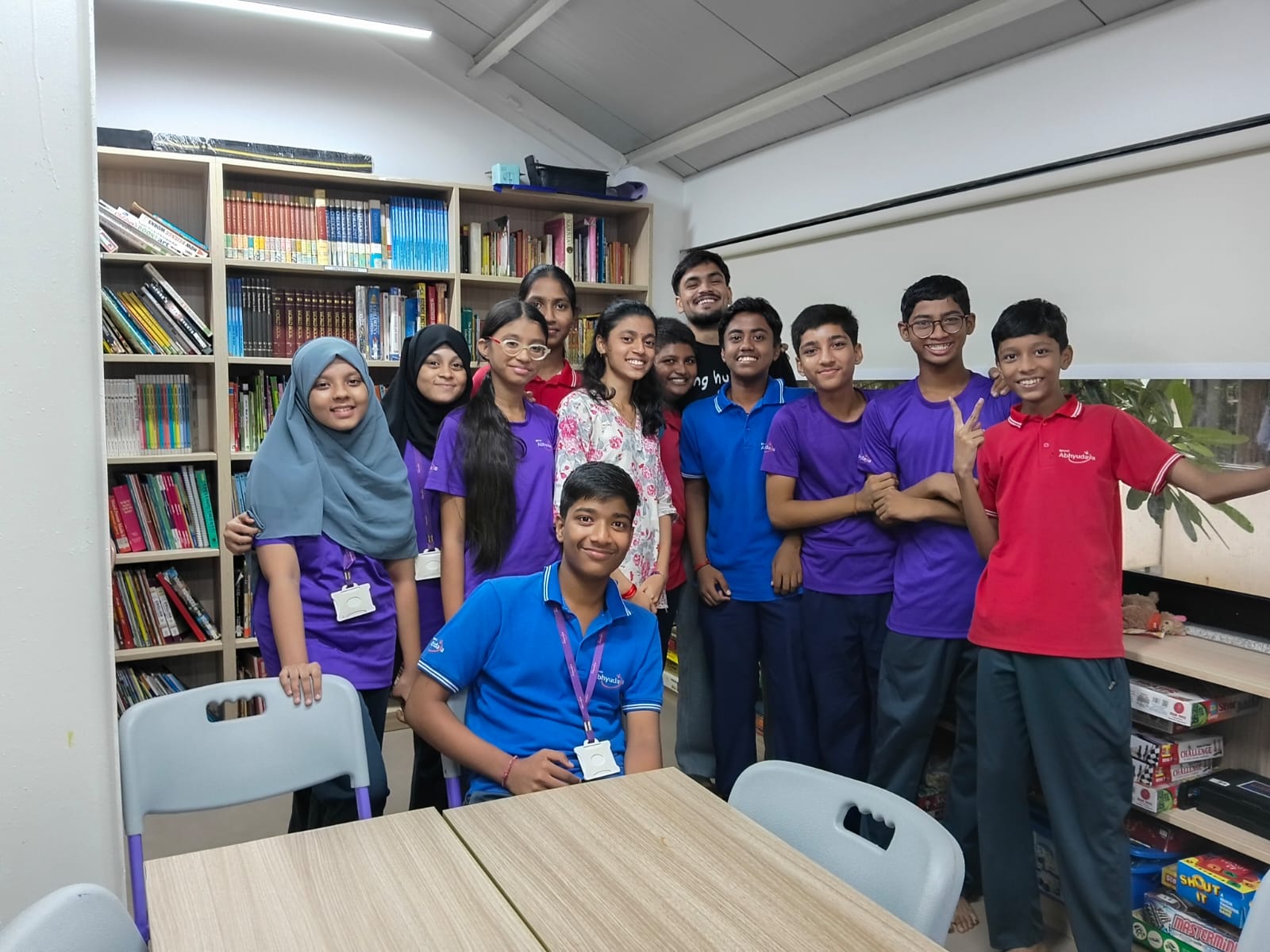Group of students smiling in a library.